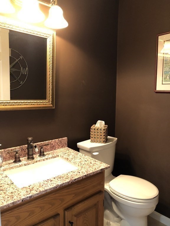36 Atkins Road, Unit B5 Sandwich, MA 02537 - Photo 10 of 23 a bathroom with a granite countertop toilet sink and mirror