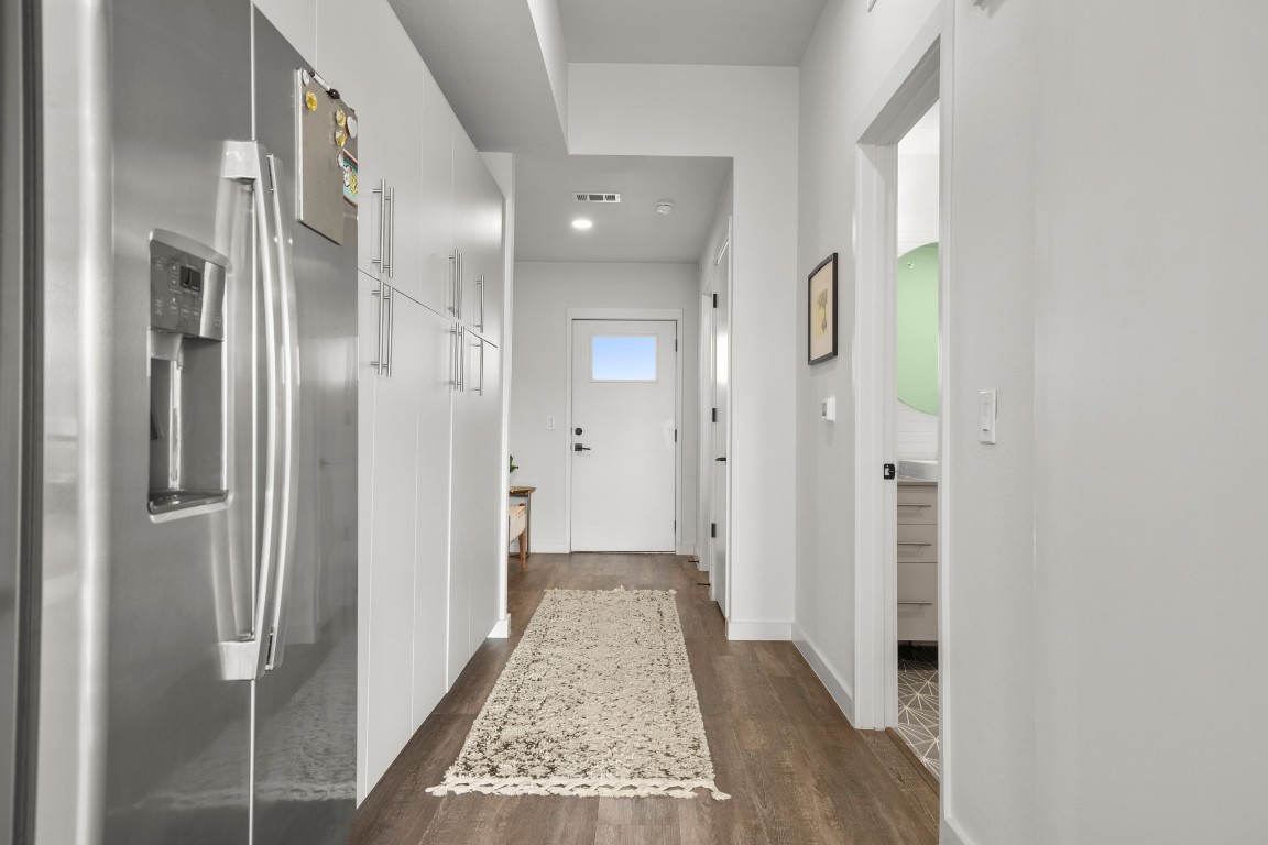 4004 Banister Lane, Unit 202 Austin, TX 78704 - Photo 3 of 23 a view of a hallway with wooden floor and a bathroom