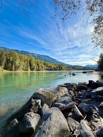 a view of a lake with lawn chairs