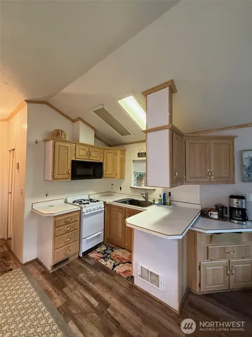 a kitchen with a sink stove top oven and cabinets