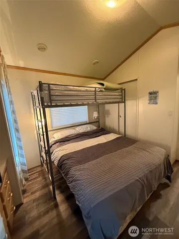 a bedroom with a bed and a mirror