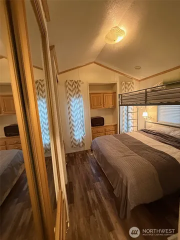 a bedroom with a bed and a mirror