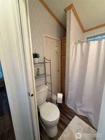 a bathroom with a granite countertop toilet a sink and a shower