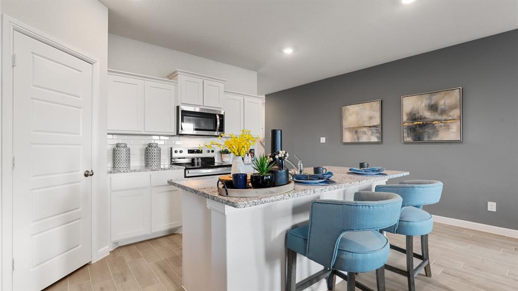 a kitchen with a dining table and chairs