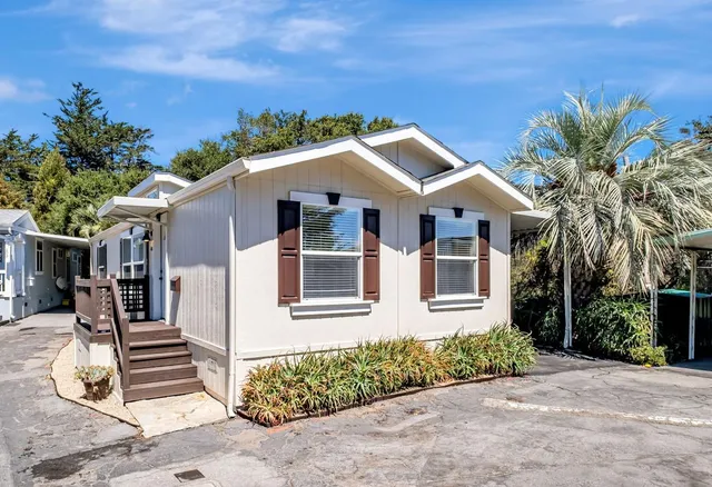 a front view of a house with a garden