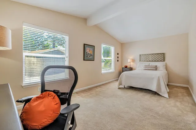 a bedroom with bed and a window