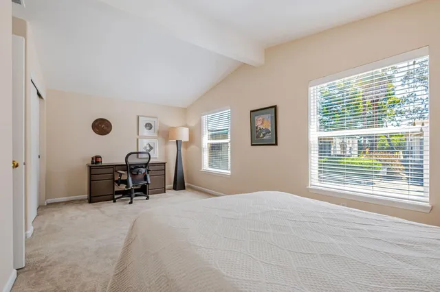 a bedroom with a bed and a large window