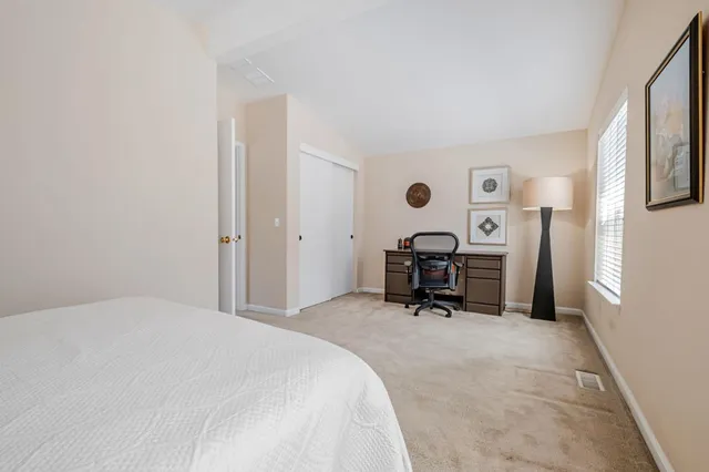 a bed room with a bed and a chair