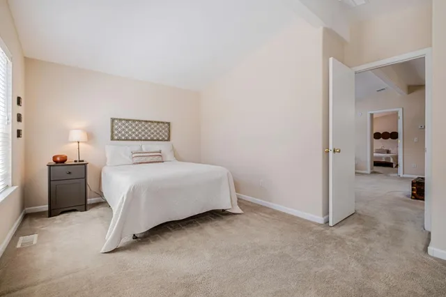 a bedroom with a bed and a view of en suite bathroom