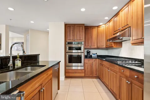 a kitchen with stainless steel appliances a sink stove and cabinets