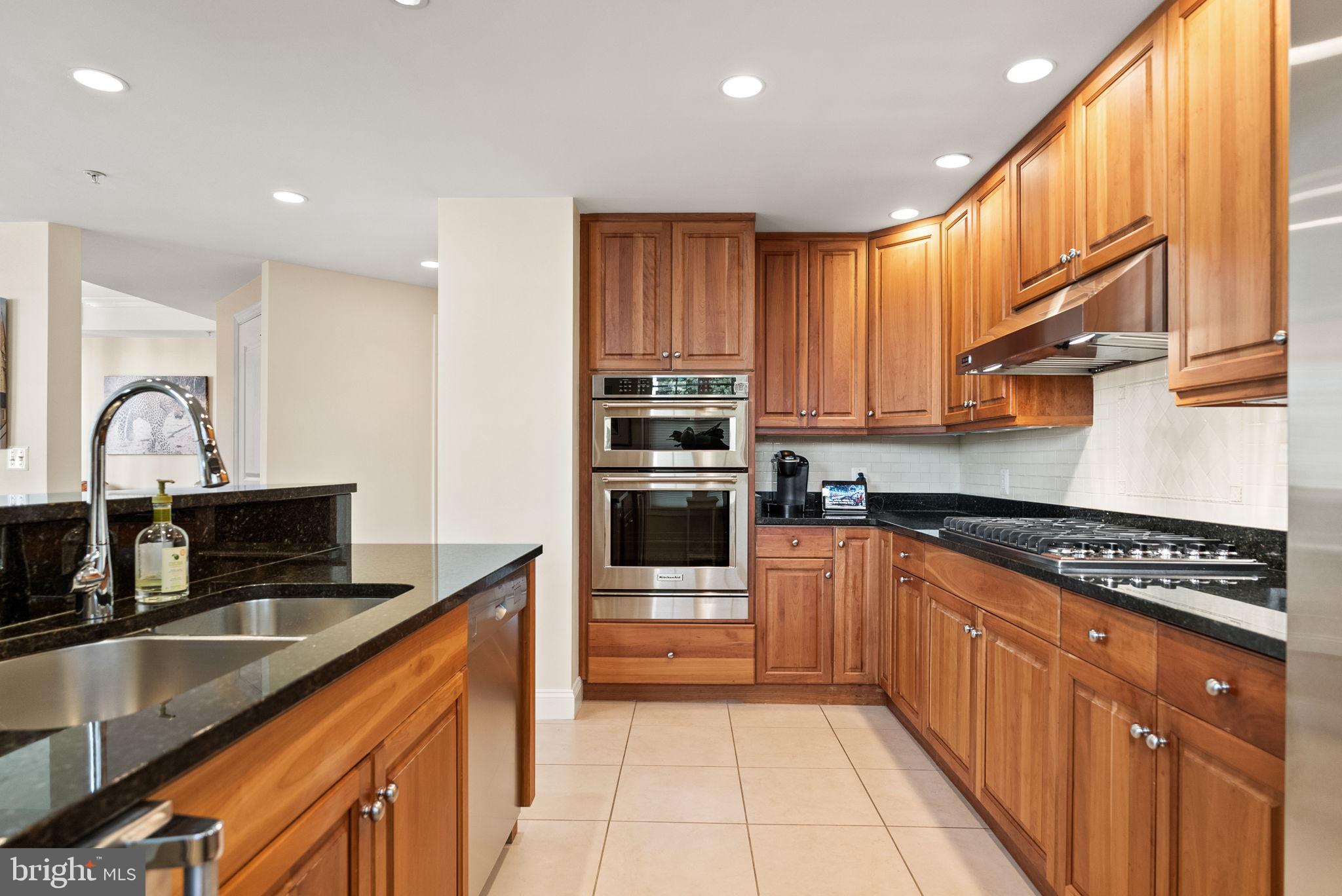2501 Wisconsin Avenue Northwest, Unit 302 Washington, DC 20007 - Photo 14 of 33 a kitchen with stainless steel appliances a sink stove and cabinets