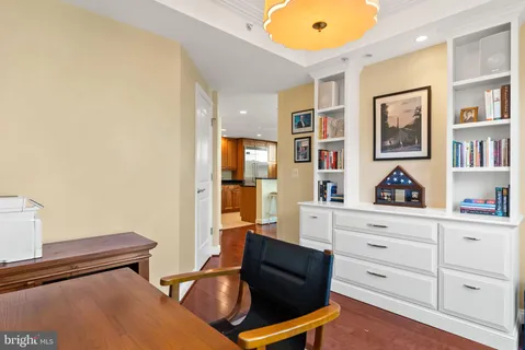 a hallway with a bed and dresser