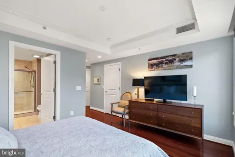 a bedroom with furniture and a flat screen tv