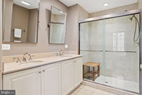 a bathroom with a double vanity sink and mirror