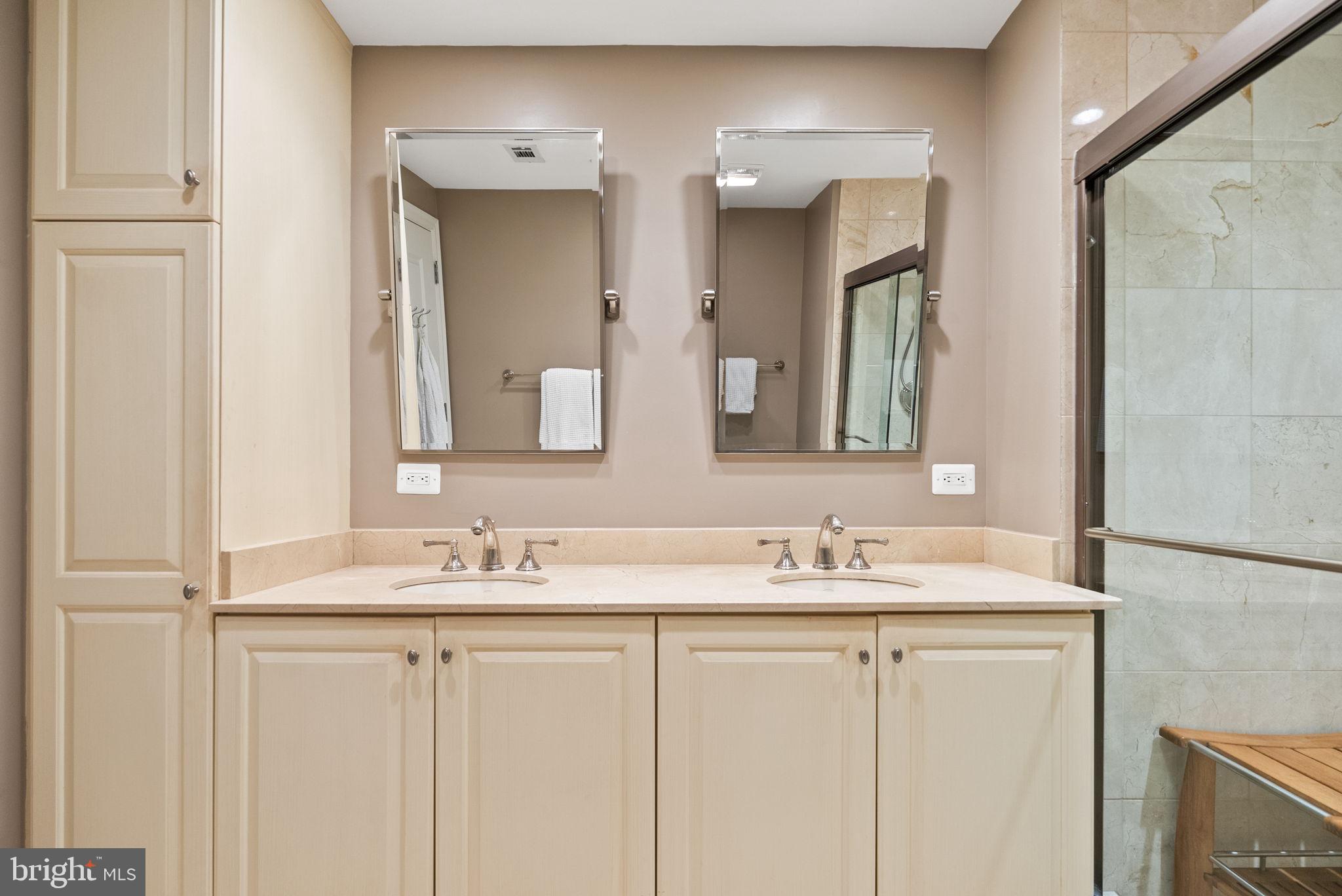2501 Wisconsin Avenue Northwest, Unit 302 Washington, DC 20007 - Photo 21 of 33 a bathroom with a double vanity sink and a mirror