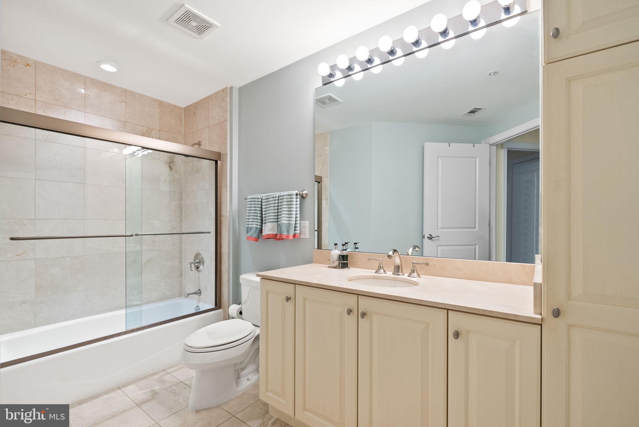 2501 Wisconsin Avenue Northwest, Unit 302 Washington, DC 20007 - Photo 24 of 33 a bathroom with a sink toilet a mirror and shower
