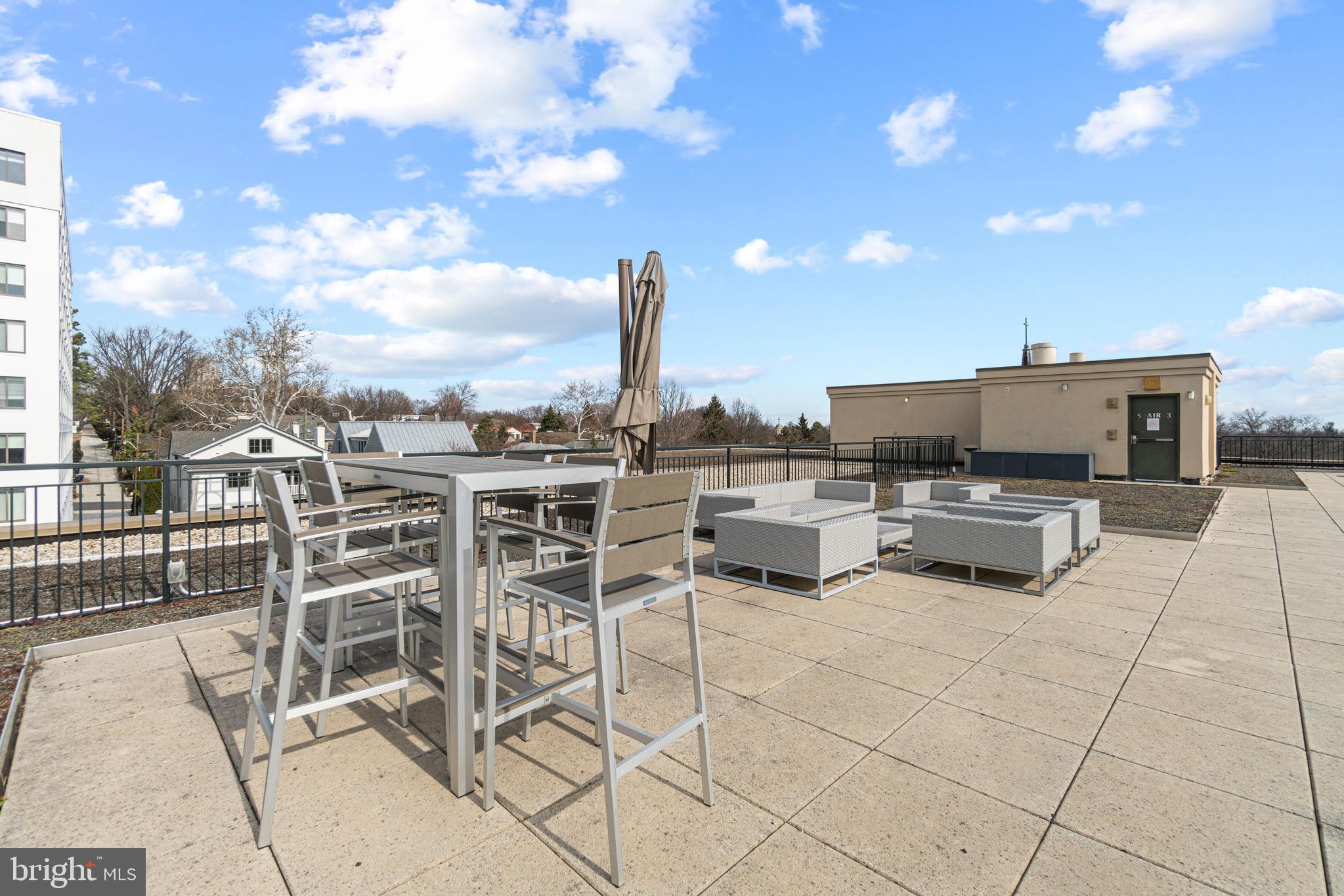 2501 Wisconsin Avenue Northwest, Unit 302 Washington, DC 20007 - Photo 26 of 33 a view of a terrace with furniture and city view
