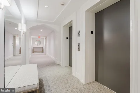 a view of a big room with chandelier and a bathroom