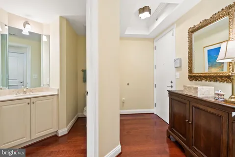 a bathroom with a sink and mirror with toilet