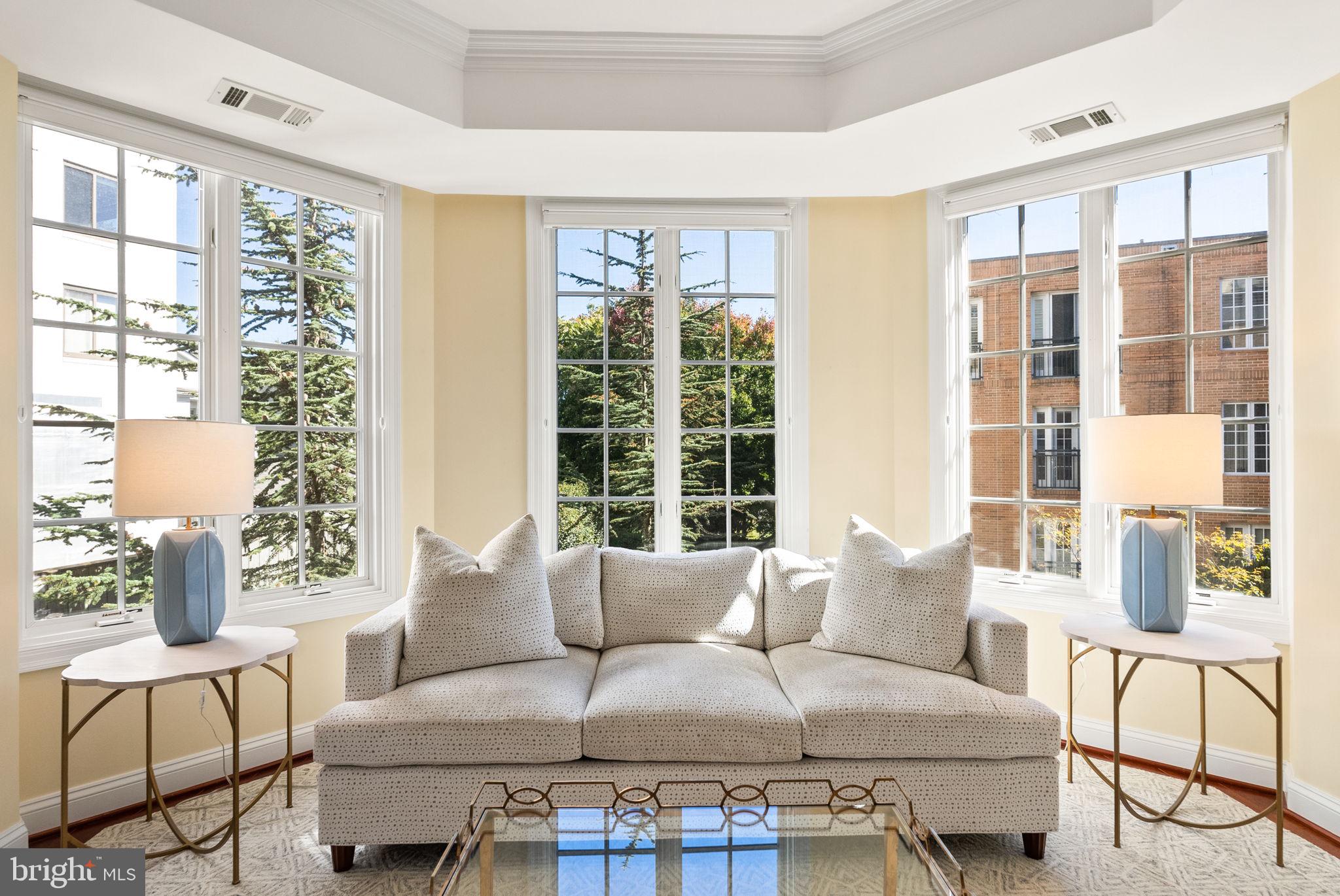 2501 Wisconsin Avenue Northwest, Unit 302 Washington, DC 20007 - Photo 8 of 33 a living room with furniture and a large window