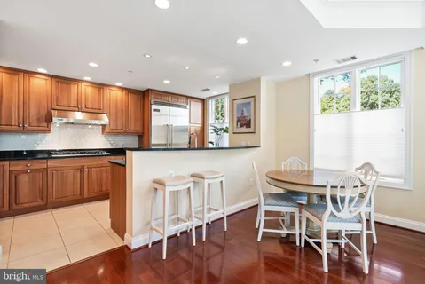 a kitchen with stainless steel appliances granite countertop a stove a sink a microwave and a refrigerator