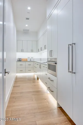 a living room with fireplace furniture and floor to ceiling window