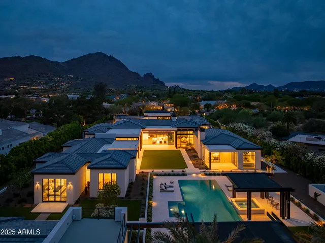 a living room with furniture and large windows