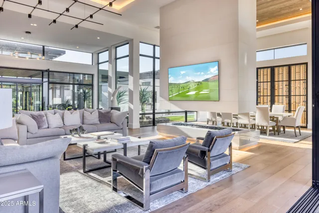 a view of a house with a swimming pool and sitting area