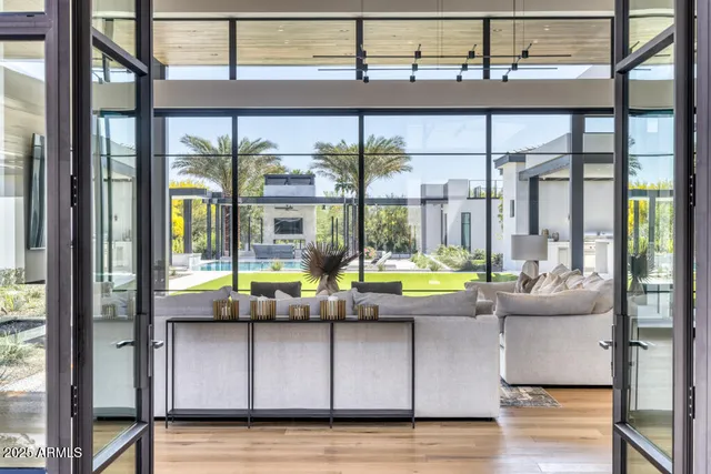 a view of a dining room with furniture a chandelier and wooden floor