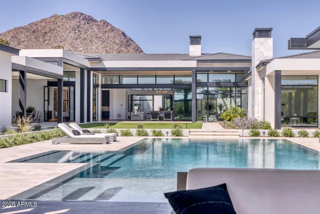 a kitchen with a dining table chairs and white cabinets