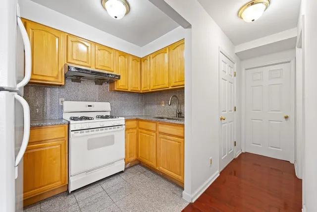 a kitchen with appliances cabinets and a sink