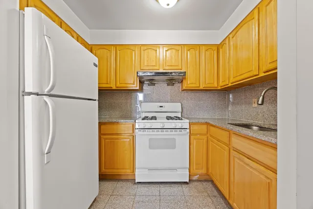 a kitchen with a refrigerator sink and cabinets