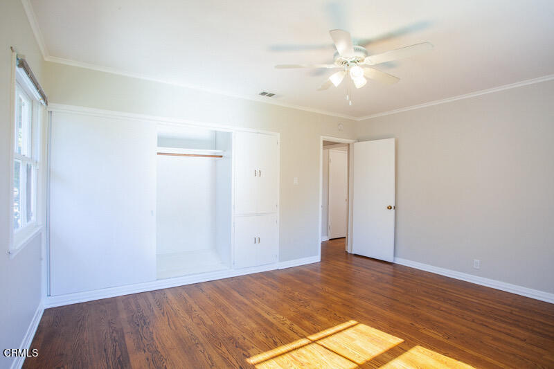 2345 Lambert Drive Pasadena, CA 91107 - Photo 13 of 25 an empty room with wooden floor and fan