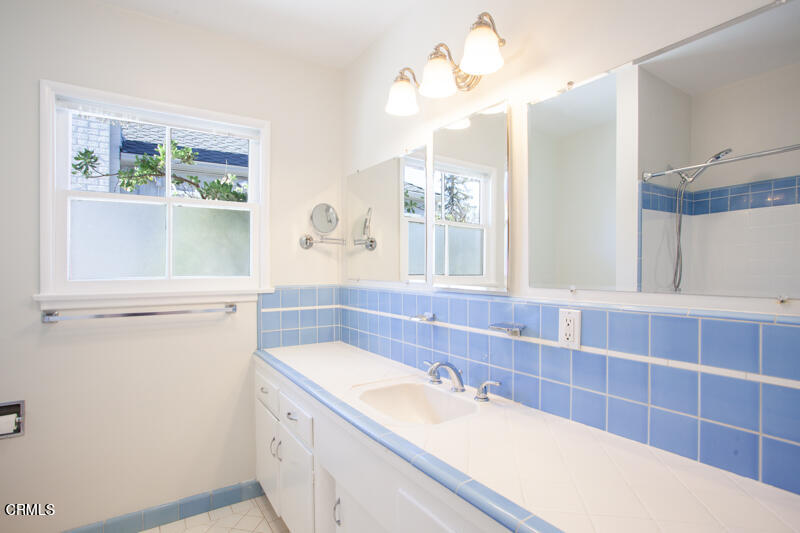 2345 Lambert Drive Pasadena, CA 91107 - Photo 14 of 25 a bathroom with a granite countertop sink a mirror and a shower