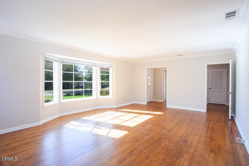 2345 Lambert Drive Pasadena, CA 91107 - Photo 2 of 25 a view of an empty room with wooden floor and a window