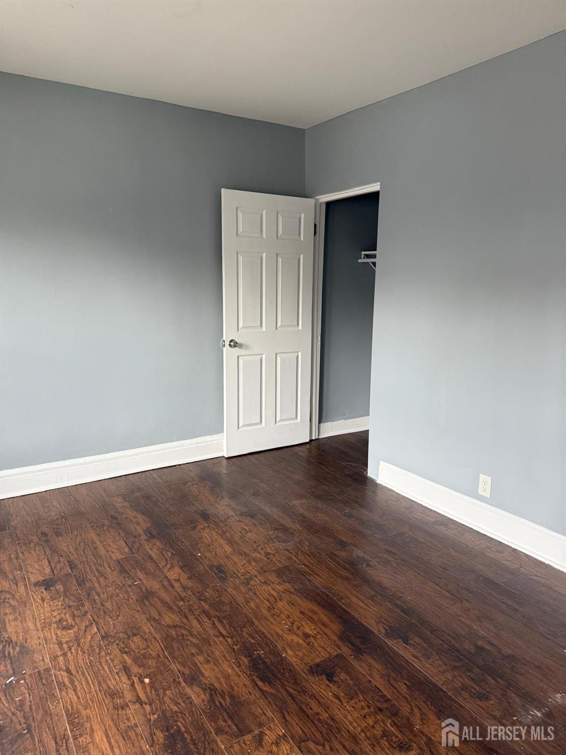 1301 South 2nd Street, Unit 1311 Plainfield, NJ 07063 - Photo 14 of 14 a view of an empty room with wooden floor and closet