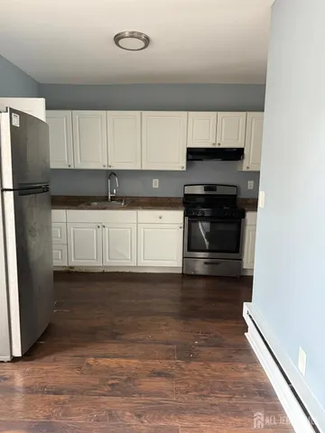 a kitchen with granite countertop a stove and a refrigerator