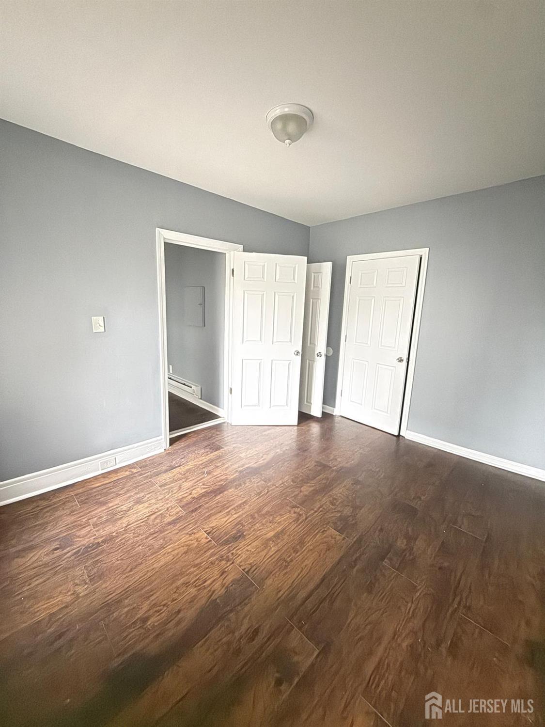 1301 South 2nd Street, Unit 1311 Plainfield, NJ 07063 - Photo 9 of 14 a view of an empty room with wooden floor and a window