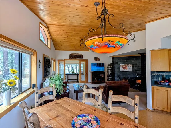 a spacious bedroom with a bed and a dresser next to a window