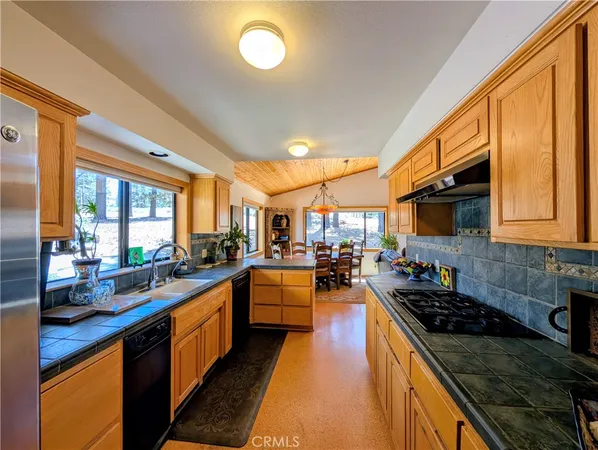 a living room with furniture a flat screen tv and a floor to ceiling window