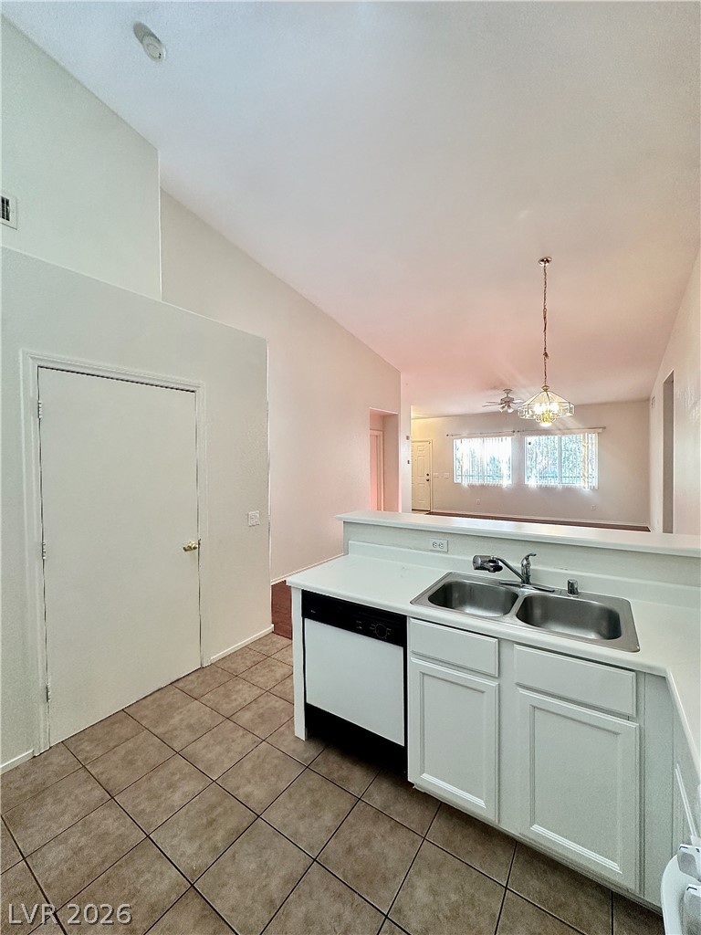 2053 Turquoise Ridge Street, Unit 202 Las Vegas, NV 89117 - Photo 3 of 18 Soaring vaulted ceilings create an open, airy feeling over the tile-floored kitchen.