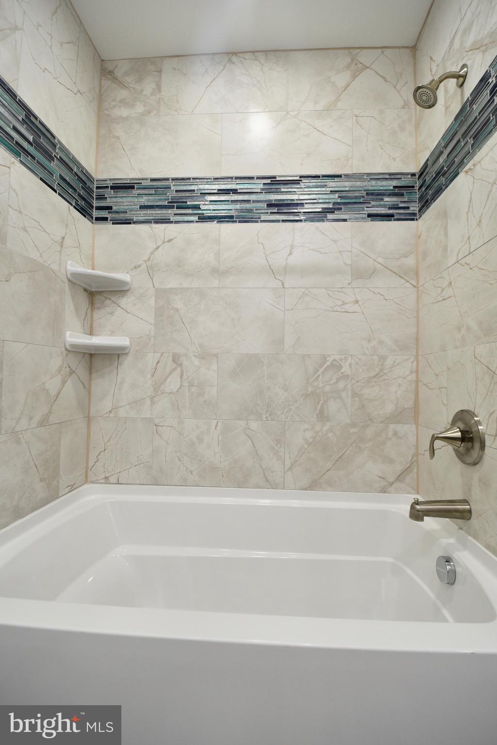 611 Main Street Sharptown, MD 21861 - Photo 11 of 37 a bathroom with a shower and a bath tub