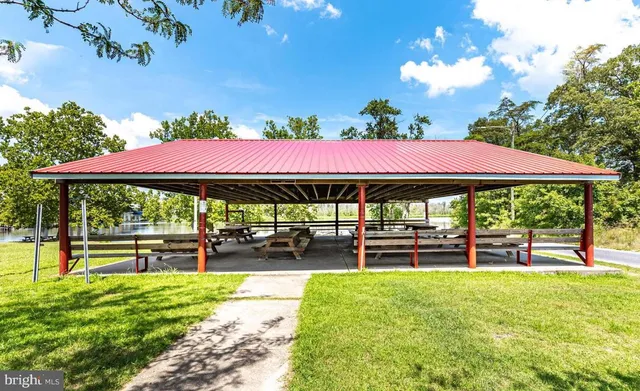 a view of a patio with a table and chairs under an umbrella