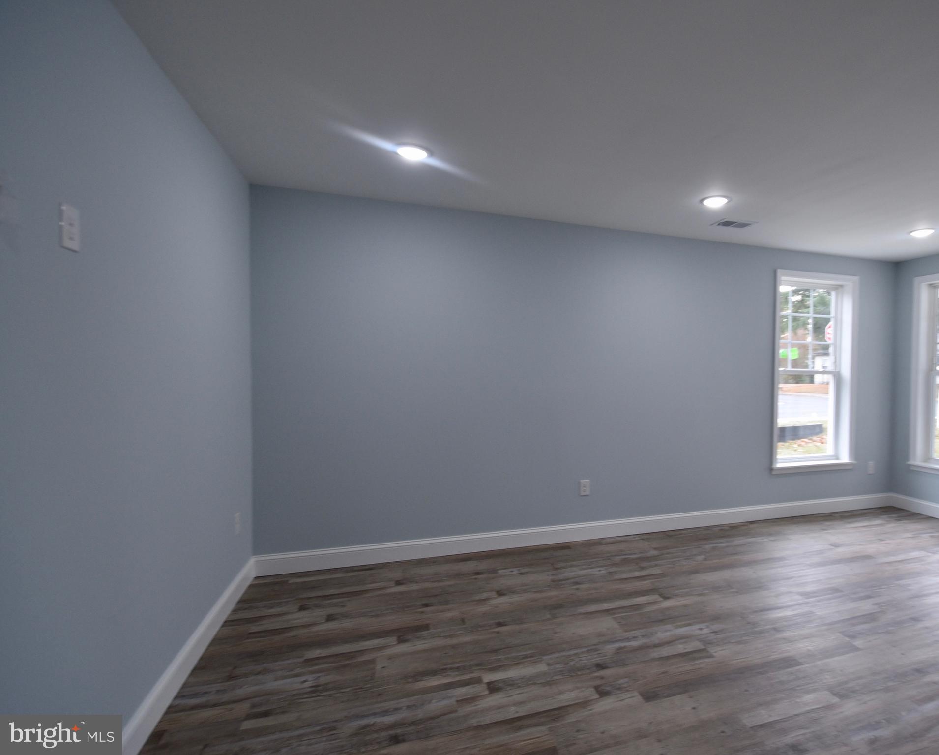 611 Main Street Sharptown, MD 21861 - Photo 12 of 37 a view of room with window and wooden floor