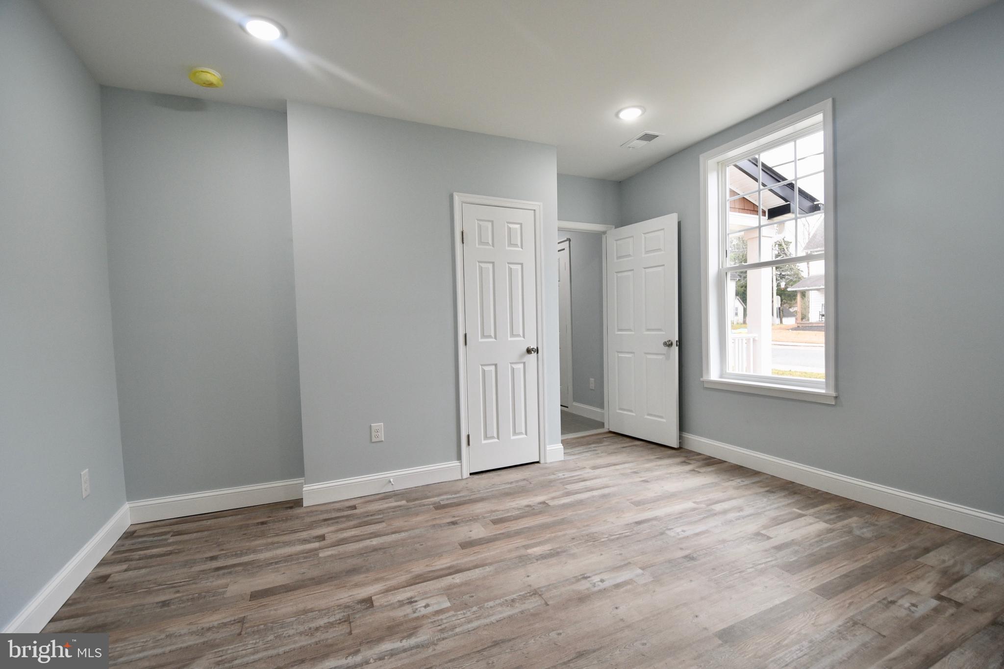 611 Main Street Sharptown, MD 21861 - Photo 17 of 37 wooden floor in an empty room with a window
