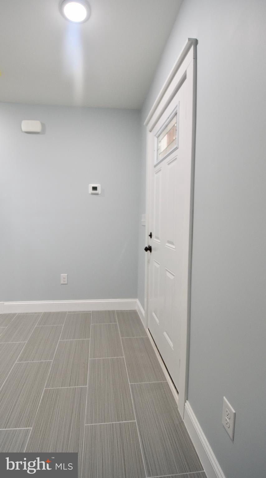 611 Main Street Sharptown, MD 21861 - Photo 18 of 37 a view of an empty room with wooden floor and a bathroom