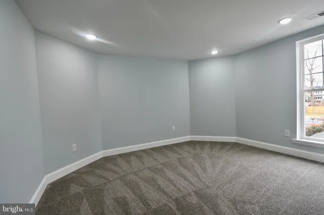 a view of an empty room and a window