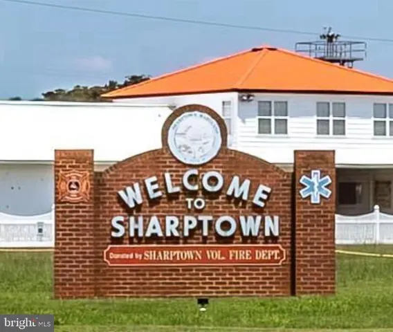 a view of a brick house with a street sign on the wall
