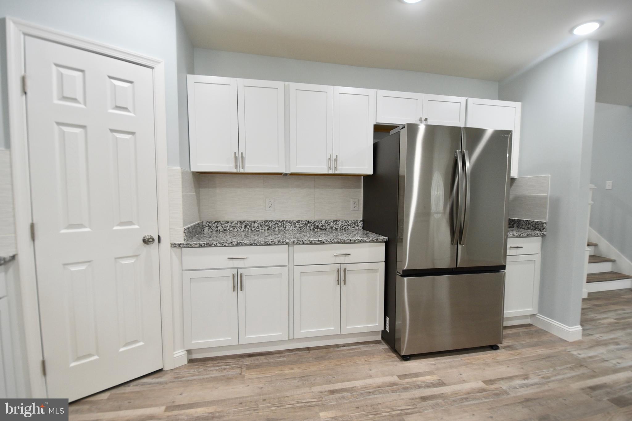 611 Main Street Sharptown, MD 21861 - Photo 6 of 37 a kitchen with stainless steel appliances granite countertop a refrigerator sink and cabinets