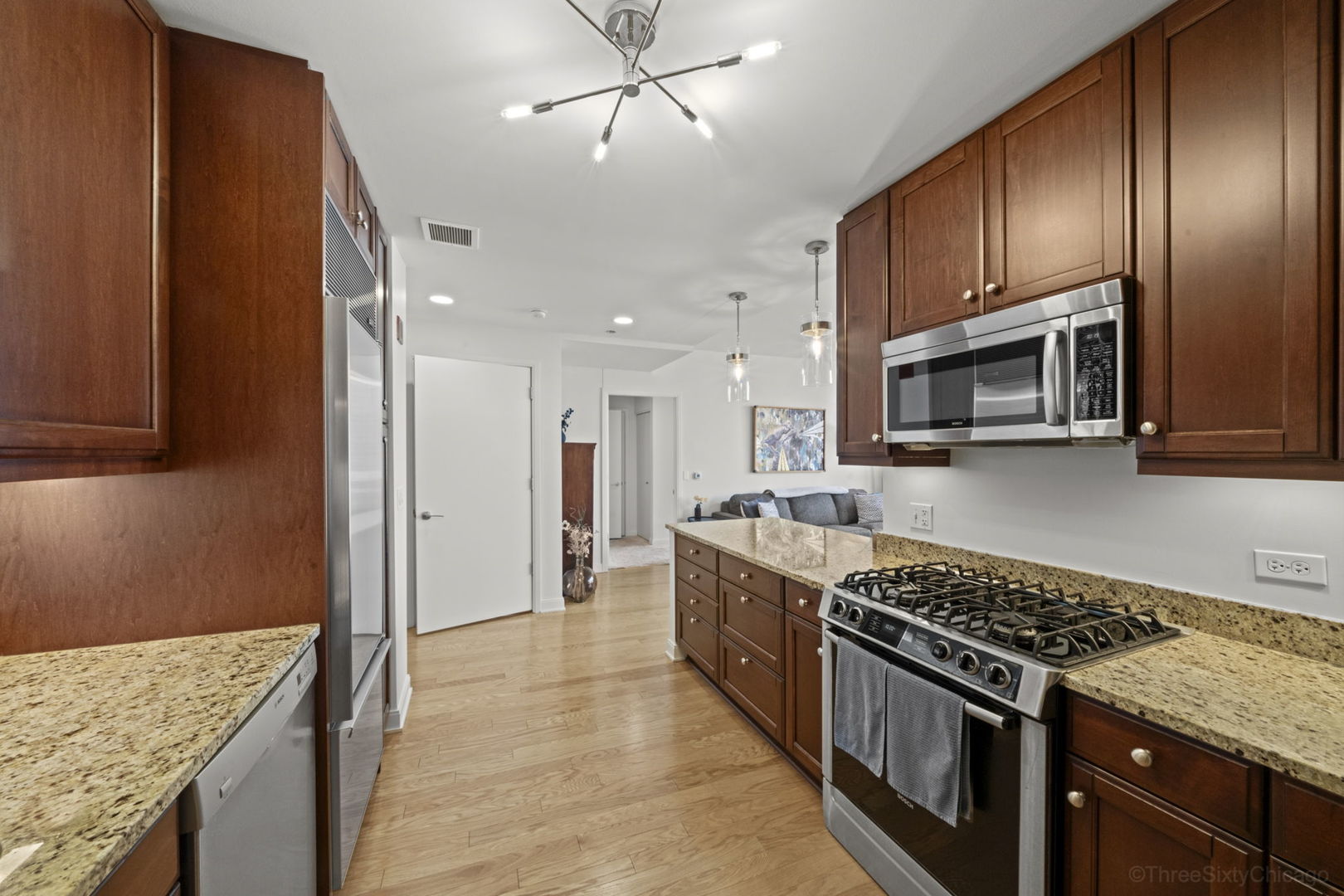 60 East Monroe Street, Unit 2606 Chicago, IL 60603 - Photo 16 of 34 a kitchen with stainless steel appliances granite countertop a stove oven and a refrigerator